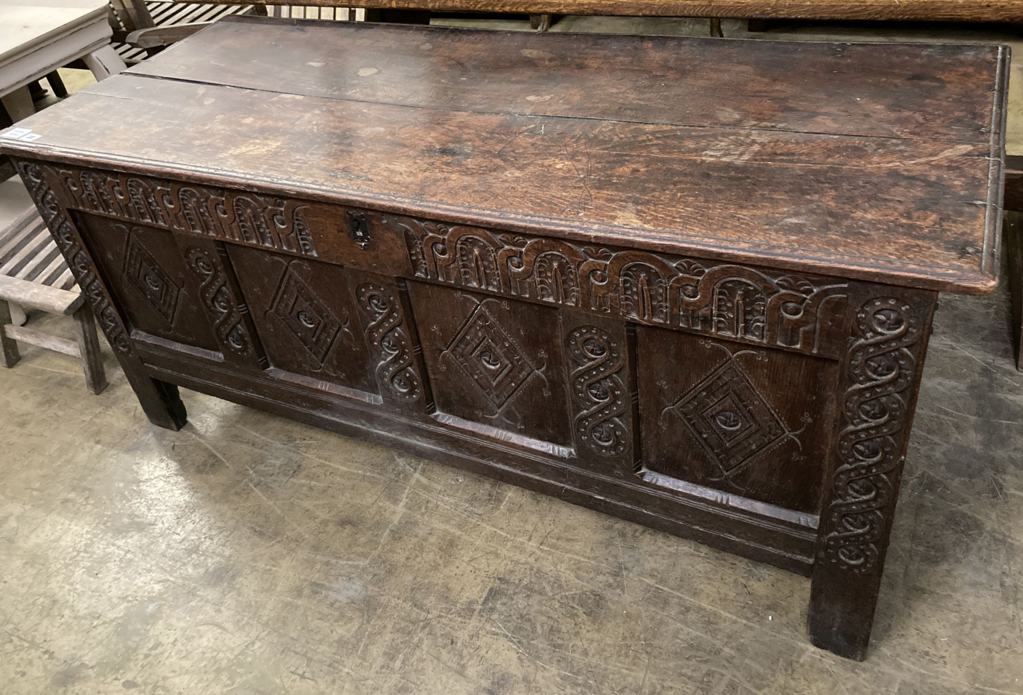 An 18th century carved panelled oak coffer, length 149cm, depth 62cm, height 67cm